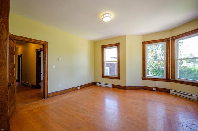 93 Broad St, Norwich, CT 06360 - spare room featuring baseboard heating, baseboards, and light wood-type flooring