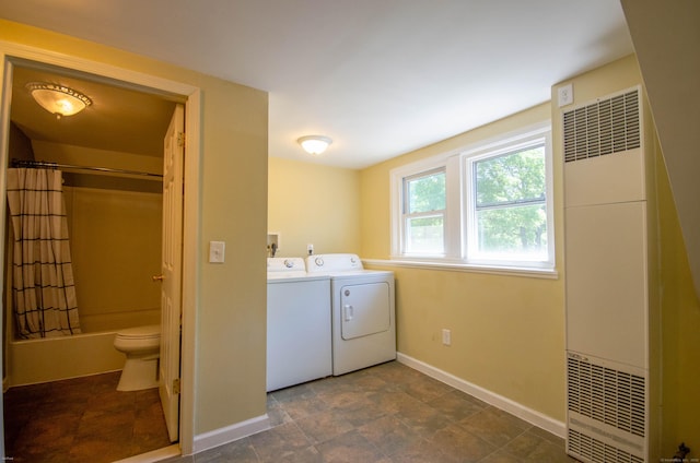 93 Broad St, Norwich, CT 06360 - laundry area featuring a heating unit, separate washer and dryer, baseboards, and stone finish flooring