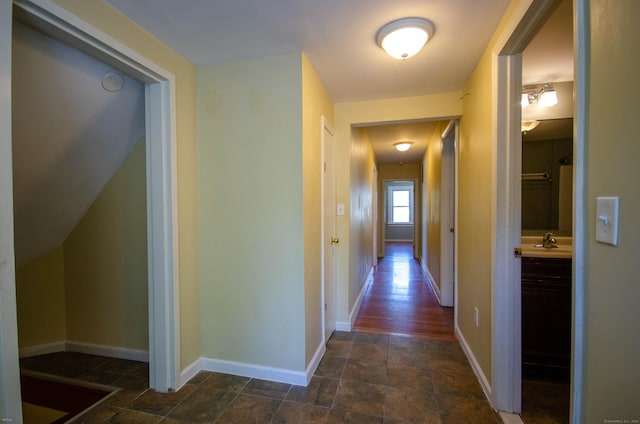 93 Broad St, Norwich, CT 06360 - hallway featuring baseboards, a sink, and dark stone finish flooring