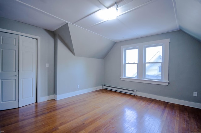 93 Broad St, Norwich, CT 06360 - additional living space with a baseboard heating unit, vaulted ceiling, baseboards, and wood finished floors