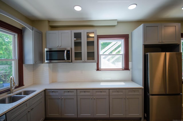 93 Broad St, Norwich, CT 06360 - kitchen with appliances with stainless steel finishes, a sink, gray cabinetry, backsplash, and recessed lighting