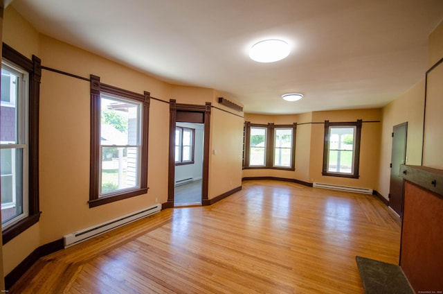 93 Broad St, Norwich, CT 06360 - unfurnished room featuring baseboard heating, a barn door, and light wood-style flooring