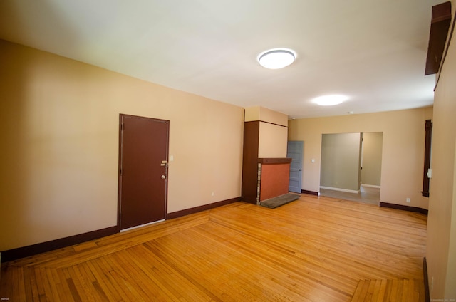 93 Broad St, Norwich, CT 06360 - unfurnished living room featuring baseboards and light wood-style flooring