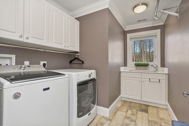 158 N Seir Hill Rd, Norwalk, CT 06850 - clothes washing area with baseboards, light wood finished floors, crown molding, washing machine and clothes dryer, and cabinet space