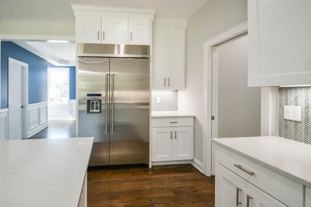 1481 Marion Rd, Cheshire, CT 06410 - kitchen with built in refrigerator, dark wood finished floors, white cabinetry, light stone countertops, and backsplash