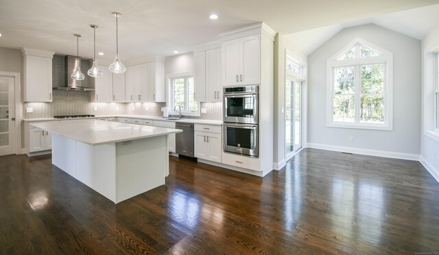 1481 Marion Rd, Cheshire, CT 06410 - kitchen featuring wall chimney range hood, appliances with stainless steel finishes, light countertops, backsplash, and white cabinetry