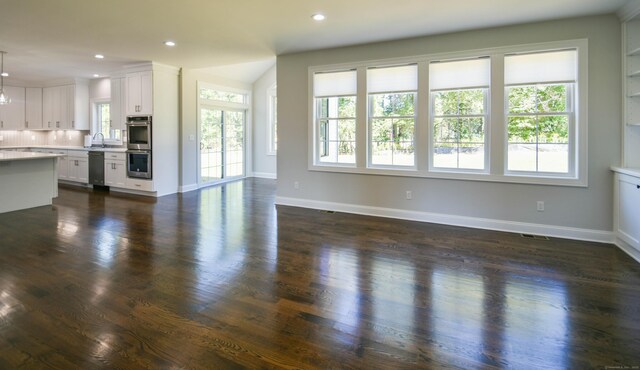 1481 Marion Rd, Cheshire, CT 06410 - unfurnished living room with plenty of natural light, a sink, recessed lighting, dark wood-type flooring, and baseboards