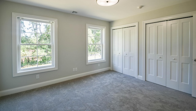 1481 Marion Rd, Cheshire, CT 06410 - unfurnished bedroom with multiple closets, multiple windows, carpet floors, and baseboards