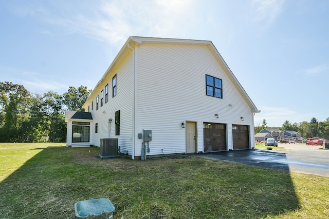 1481 Marion Rd, Cheshire, CT 06410 - view of side of home featuring driveway, an attached garage, cooling unit, and a lawn