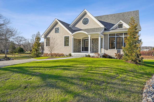 7 Egret Rd, Stonington, CT 06355 - view of front of home featuring a front lawn and roof with shingles