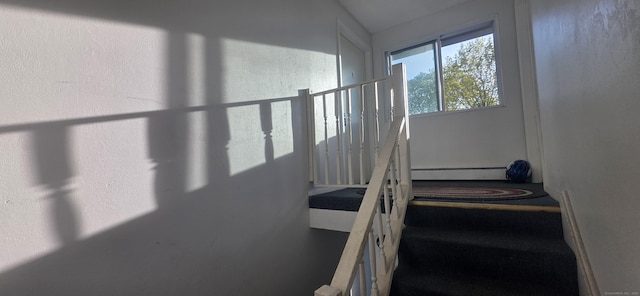 stairway with a baseboard radiator