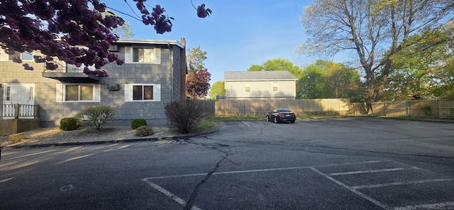 exterior space featuring uncovered parking and fence
