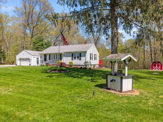 8 Dean Rd, East Lyme, CT 06333 - view of front of home featuring a storage unit, an outbuilding, a chimney, and a front lawn