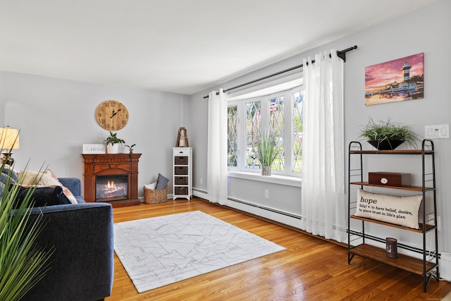 8 Dean Rd, East Lyme, CT 06333 - living area featuring a glass covered fireplace and wood finished floors