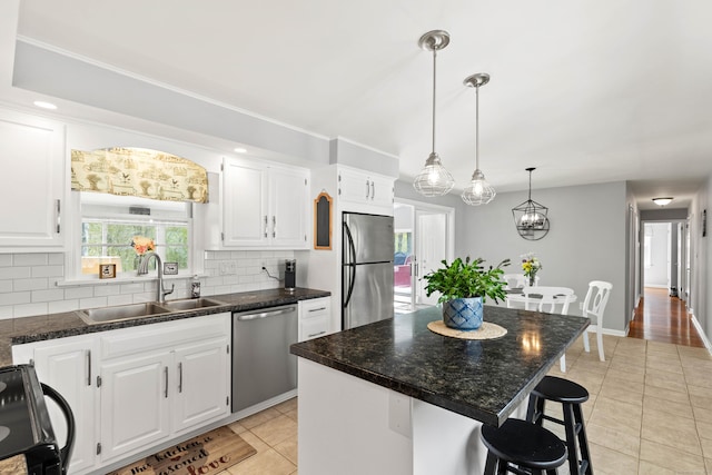 8 Dean Rd, East Lyme, CT 06333 - kitchen featuring appliances with stainless steel finishes, a sink, tasteful backsplash, and light tile patterned floors