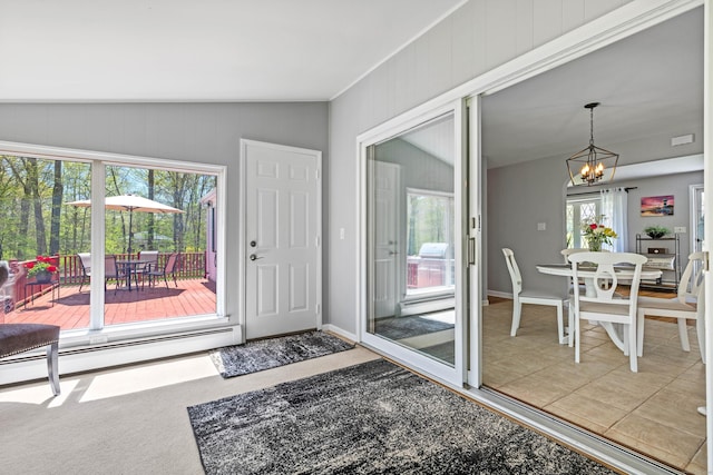 8 Dean Rd, East Lyme, CT 06333 - doorway to outside featuring baseboard heating, a chandelier, light tile patterned floors, baseboards, and vaulted ceiling