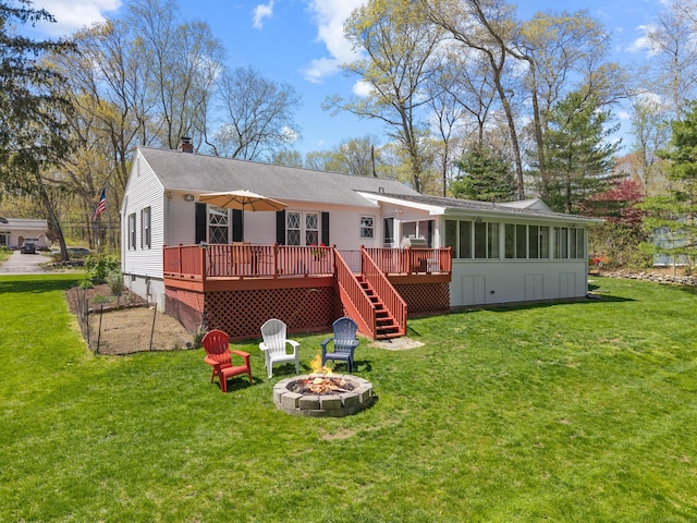 8 Dean Rd, East Lyme, CT 06333 - back of house with a wooden deck, an outdoor fire pit, a yard, a chimney, and a sunroom