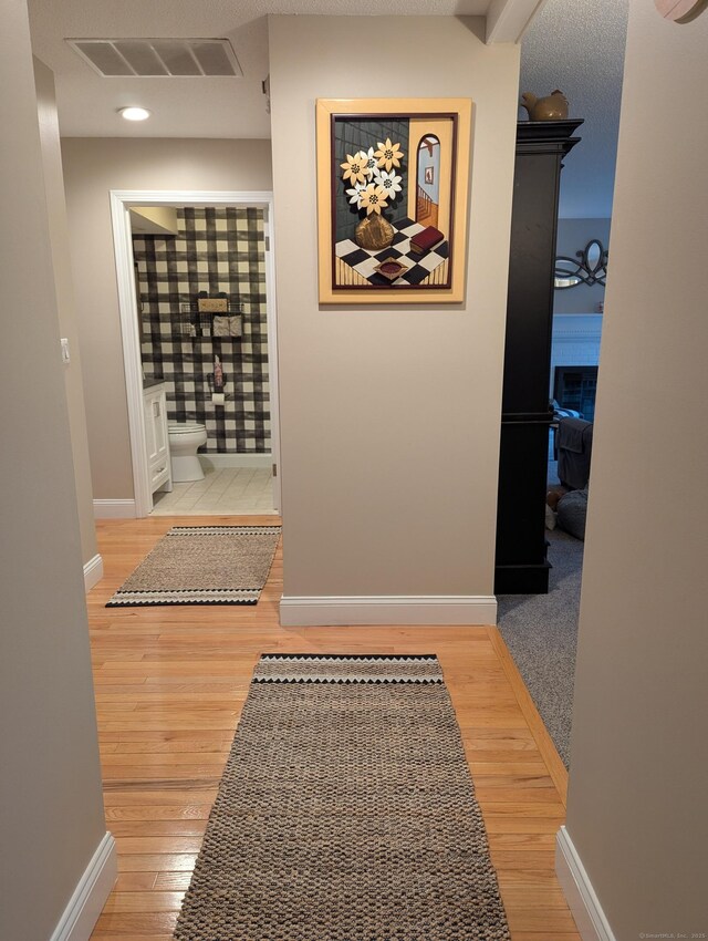 374 Heritage Vlg Unit C, Southbury, CT 06488 - hall featuring baseboards, wood finished floors, and visible vents