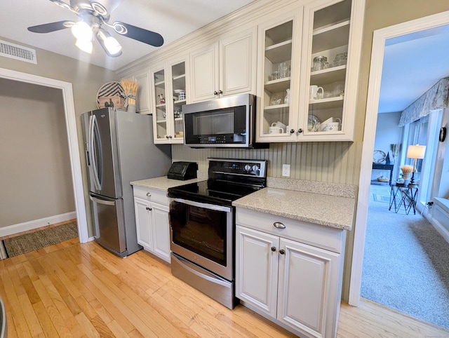374 Heritage Vlg Unit C, Southbury, CT 06488 - kitchen with light wood finished floors, stainless steel appliances, a ceiling fan, visible vents, and glass insert cabinets