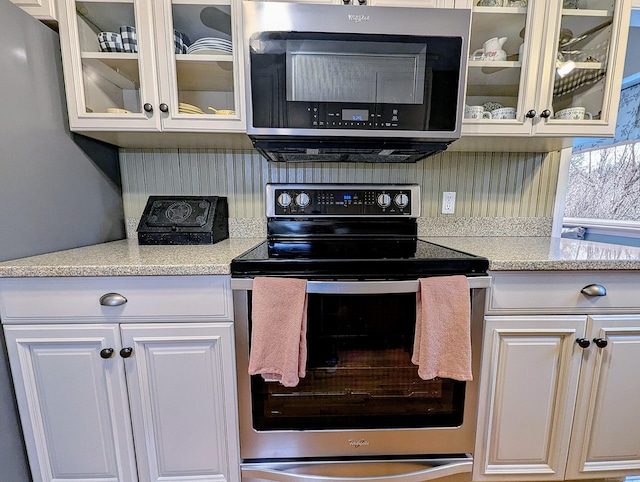 374 Heritage Vlg Unit C, Southbury, CT 06488 - kitchen featuring glass insert cabinets, decorative backsplash, stainless steel appliances, and white cabinets