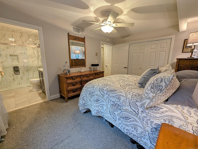 374 Heritage Vlg Unit C, Southbury, CT 06488 - carpeted bedroom featuring visible vents, a closet, ensuite bathroom, ceiling fan, and a textured ceiling