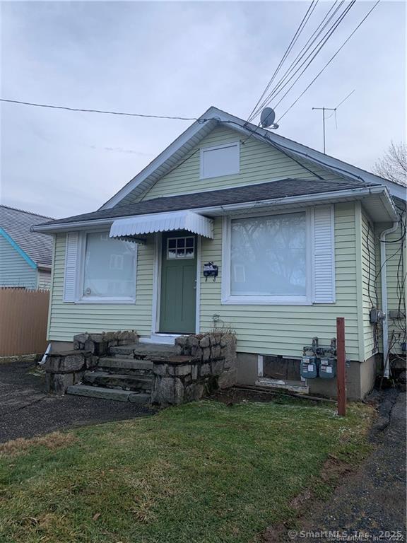 bungalow-style home featuring fence and a front yard