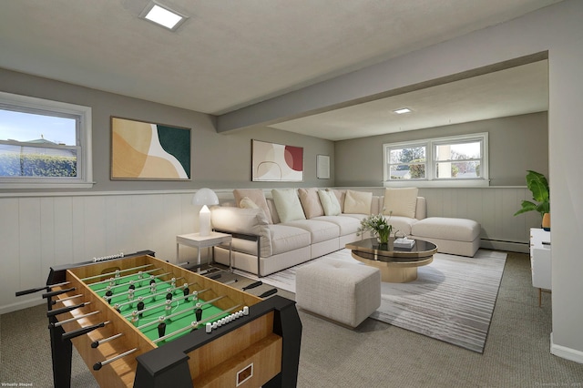 interior space featuring baseboard heating, wainscoting, and beam ceiling