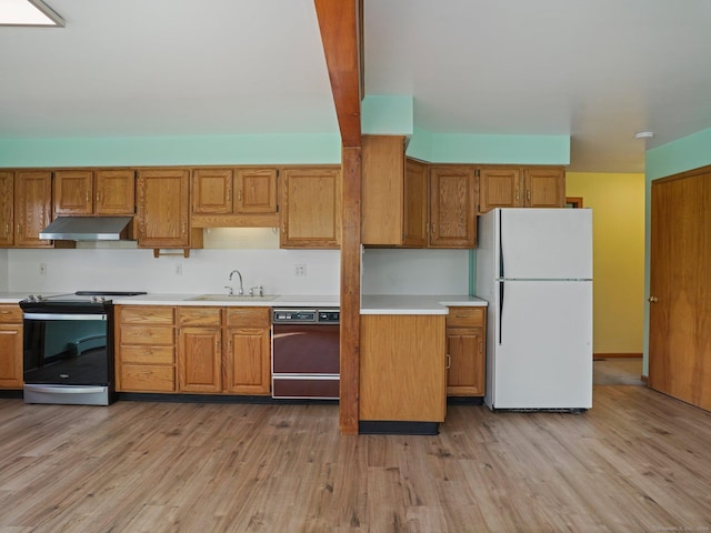 kitchen with stainless steel electric range oven, dishwasher, under cabinet range hood, a sink, and freestanding refrigerator