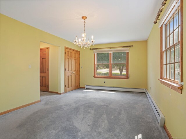 empty room with baseboards, a baseboard radiator, carpet flooring, and an inviting chandelier