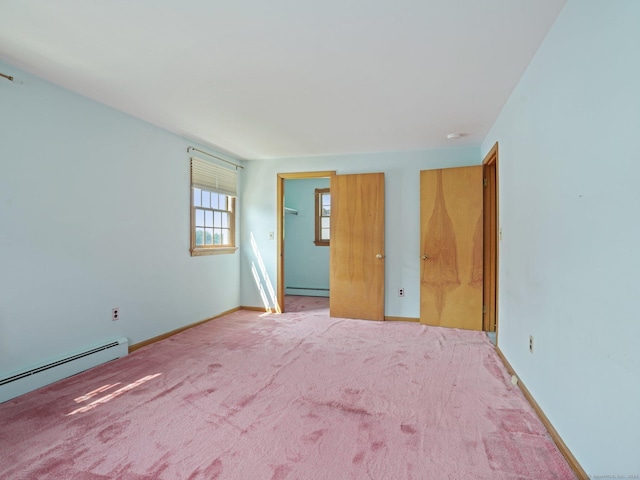 carpeted spare room featuring baseboards and baseboard heating