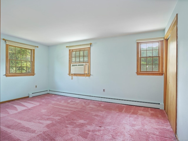 empty room with a baseboard heating unit and carpet