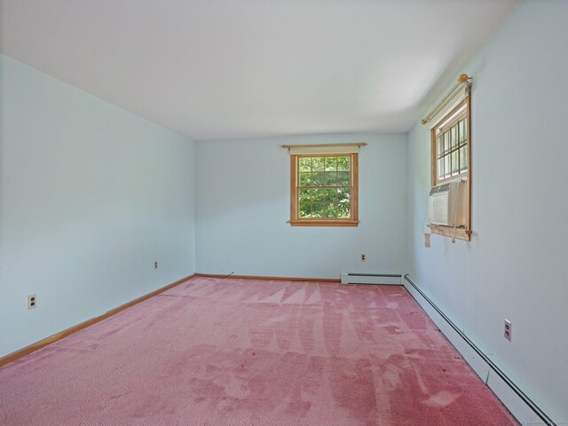 empty room featuring baseboards, carpet floors, and baseboard heating