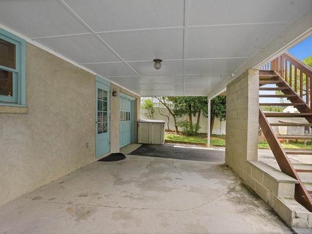 view of patio with fence and stairs