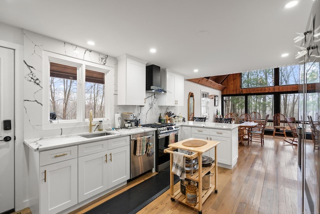 162 Hattertown Rd, Newtown, CT 06470 - kitchen featuring a peninsula, appliances with stainless steel finishes, wall chimney exhaust hood, a sink, and white cabinets
