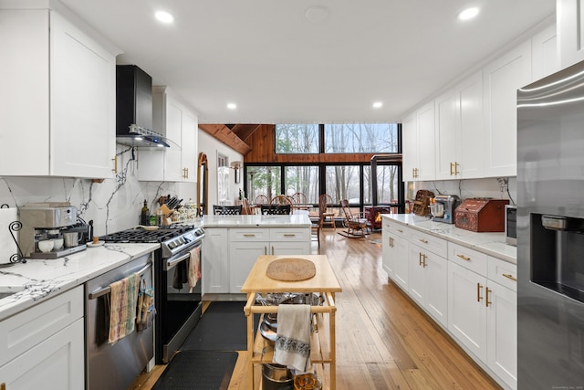 162 Hattertown Rd, Newtown, CT 06470 - kitchen with appliances with stainless steel finishes, wall chimney exhaust hood, tasteful backsplash, a peninsula, and recessed lighting