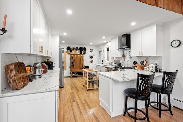 162 Hattertown Rd, Newtown, CT 06470 - kitchen with wall chimney exhaust hood, a peninsula, recessed lighting, tasteful backsplash, and white cabinets