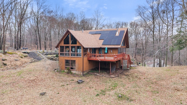 162 Hattertown Rd, Newtown, CT 06470 - rear view of house featuring a shingled roof, roof mounted solar panels, a wooden deck, and stairs