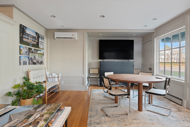 24-26 Lyme St, Old Lyme, CT 06371 - dining space with light wood-type flooring, baseboard heating, a decorative wall, an AC wall unit, and recessed lighting