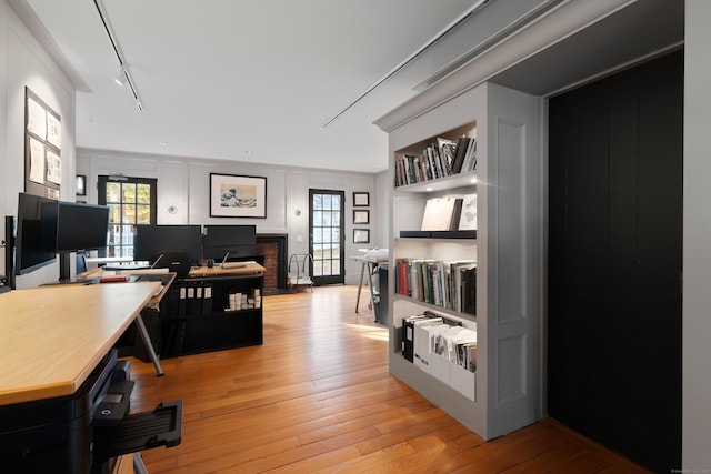 24-26 Lyme St, Old Lyme, CT 06371 - home office with built in features, a decorative wall, light wood-style floors, and a wealth of natural light