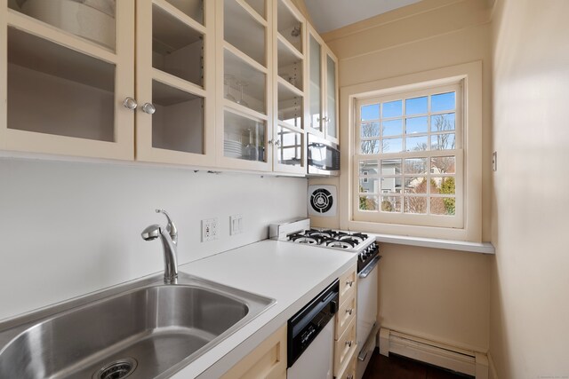 24-26 Lyme St, Old Lyme, CT 06371 - kitchen featuring light countertops, white appliances, a sink, a baseboard radiator, and glass insert cabinets