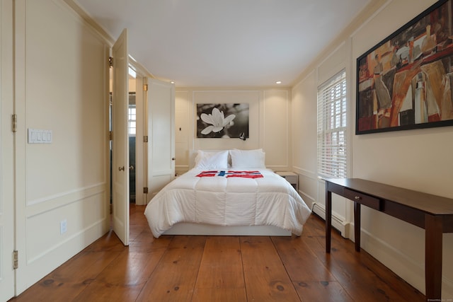 24-26 Lyme St, Old Lyme, CT 06371 - bedroom featuring hardwood / wood-style floors, a decorative wall, and a baseboard heating unit
