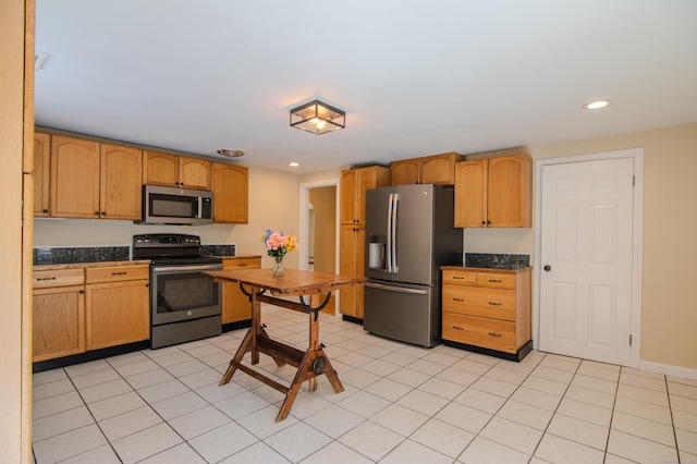 kitchen with stainless steel appliances, dark countertops, recessed lighting, and light tile patterned floors