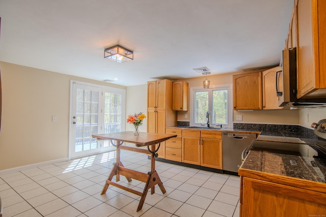 kitchen with visible vents, light tile patterned flooring, tile countertops, a sink, and stainless steel appliances
