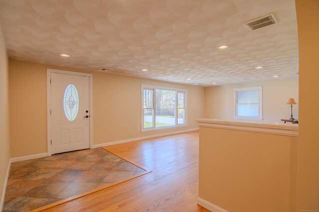 foyer entrance featuring recessed lighting, baseboards, visible vents, and light wood-type flooring