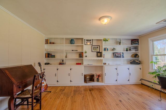 living area with visible vents, ornamental molding, and light wood-type flooring