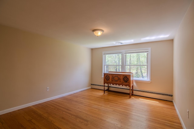 living area with visible vents, light wood-style flooring, baseboards, and baseboard heating