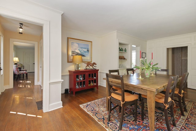 167 Skunk Ln, Wilton, CT 06897 - dining space with wood-type flooring, crown molding, and baseboards