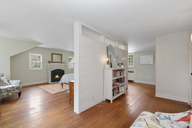 167 Skunk Ln, Wilton, CT 06897 - living area featuring light wood-style floors, a warm lit fireplace, plenty of natural light, and baseboards