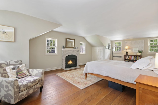 167 Skunk Ln, Wilton, CT 06897 - bedroom with hardwood / wood-style flooring, a fireplace, and baseboards