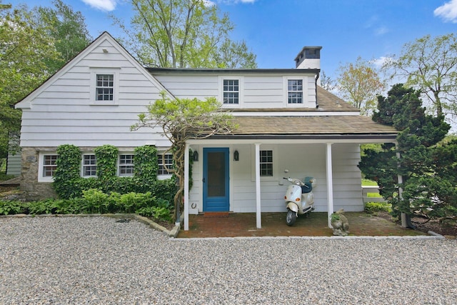 167 Skunk Ln, Wilton, CT 06897 - view of front of property with a chimney and a porch
